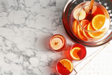 Photo of Fruity punch on white marble table, flat lay with space for text. Refreshing drink