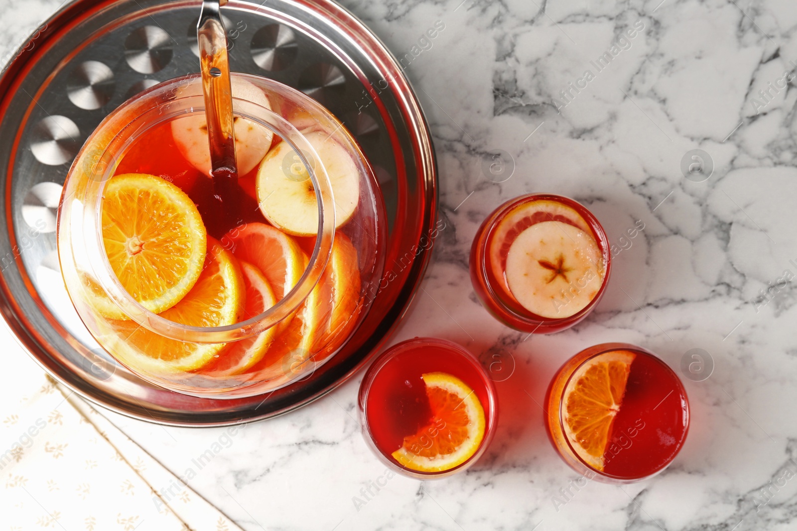 Fruity punch on white marble table, flat lay. Refreshing drink Photo of Fruity punch on white marble table, flat lay. Refreshing drink