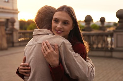 Photo of Goodbye. Lovely couple hugging on city street
