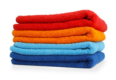 Photo of Stack of colorful terry towels isolated on white