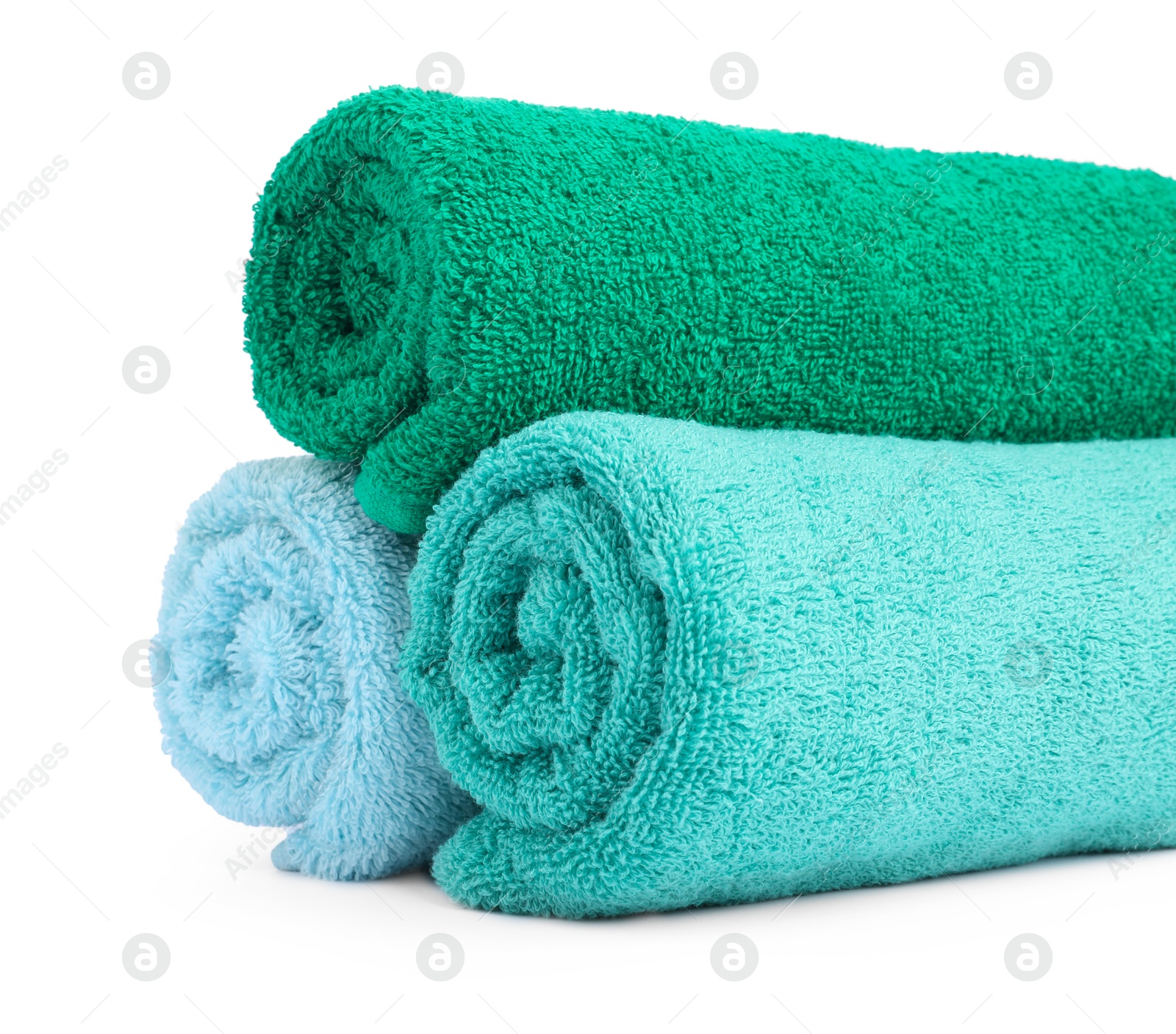 Photo of Colorful rolled terry towels isolated on white