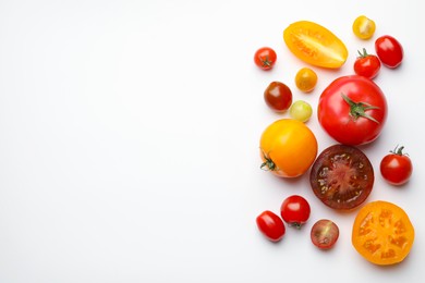 Photo of Different ripe tomatoes on white table, flat lay. Space for text