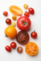Photo of Different ripe tomatoes on white table, flat lay