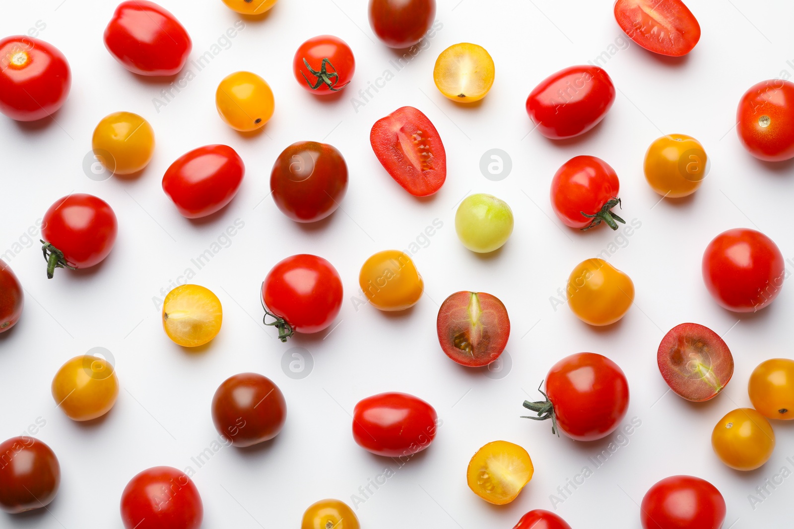 Photo of Different ripe tomatoes on white table, flat lay