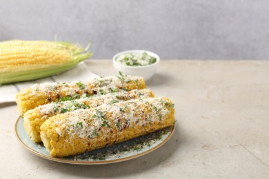 Photo of Tasty grilled corncobs with parsley and cheese on light table. Space for text