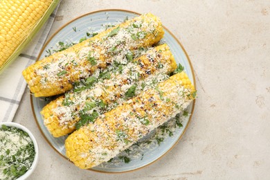 Photo of Tasty grilled corncobs with parsley and cheese on light table, flat lay