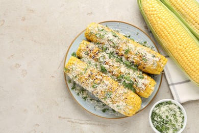 Photo of Tasty grilled corncobs with parsley and cheese on light table, flat lay. Space for text
