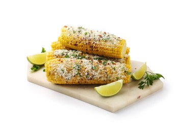 Photo of Tasty grilled corncobs with parsley, cheese and lime slices isolated on white