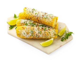 Photo of Tasty grilled corncobs with parsley, cheese and lime slices isolated on white