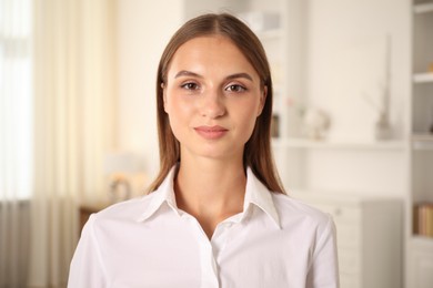 Photo of Portrait of beautiful young woman at home