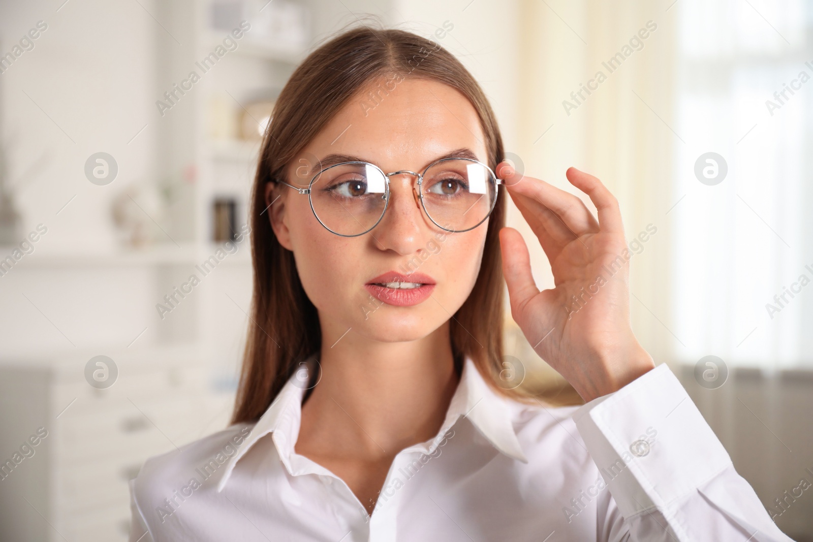 Photo of Portrait of beautiful young woman at home