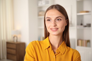 Photo of Portrait of beautiful young woman at home. Space for text