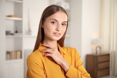 Photo of Portrait of beautiful young woman at home