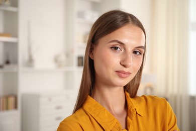 Photo of Portrait of beautiful young woman at home