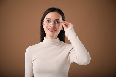 Photo of Portrait of beautiful woman on brown background
