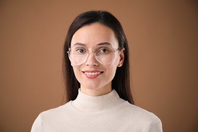 Photo of Portrait of beautiful woman on brown background