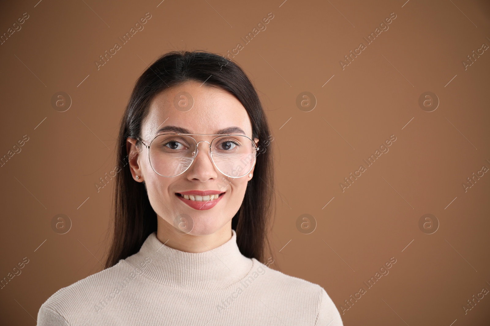 Photo of Portrait of beautiful woman on brown background. Space for text