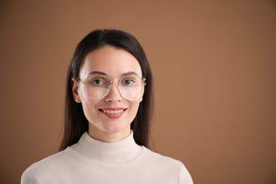 Photo of Portrait of beautiful woman on brown background. Space for text