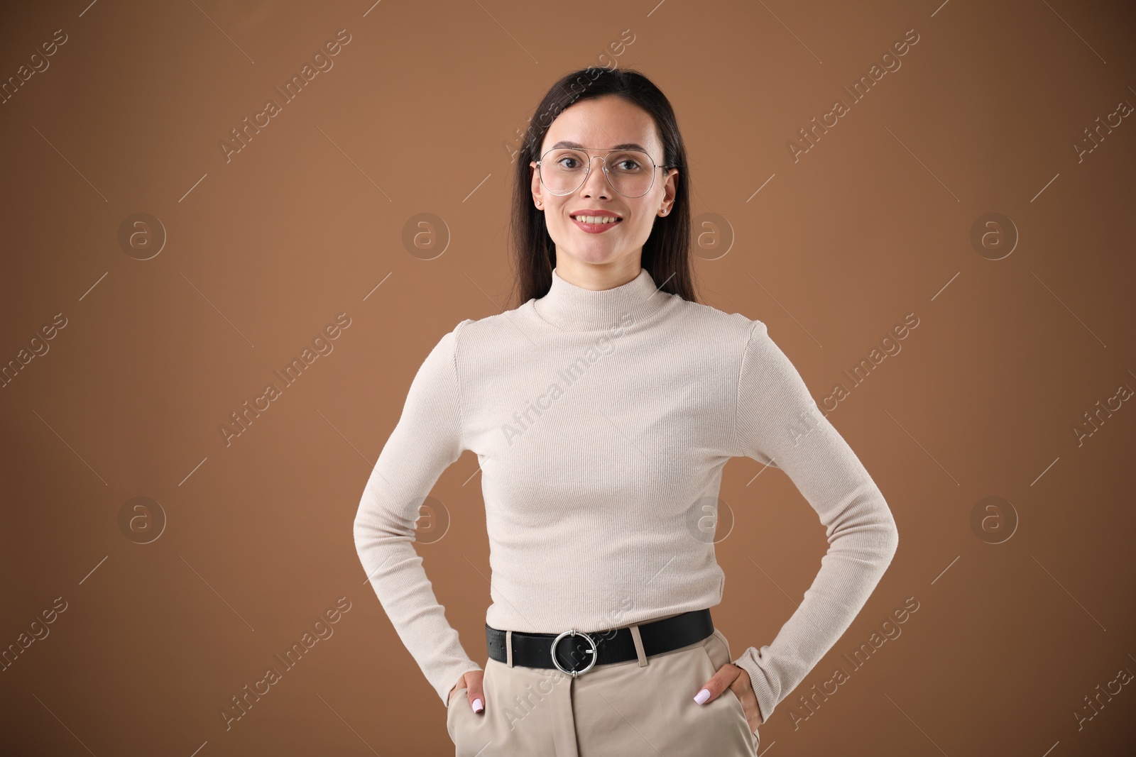 Photo of Portrait of beautiful woman on brown background