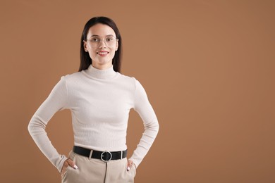 Photo of Portrait of beautiful woman on brown background. Space for text
