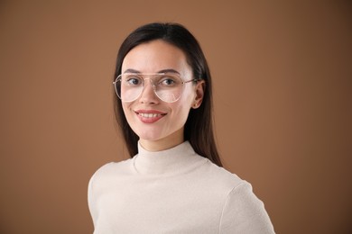Photo of Portrait of beautiful woman on brown background