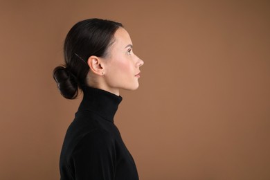 Photo of Portrait of beautiful woman on brown background. Space for text