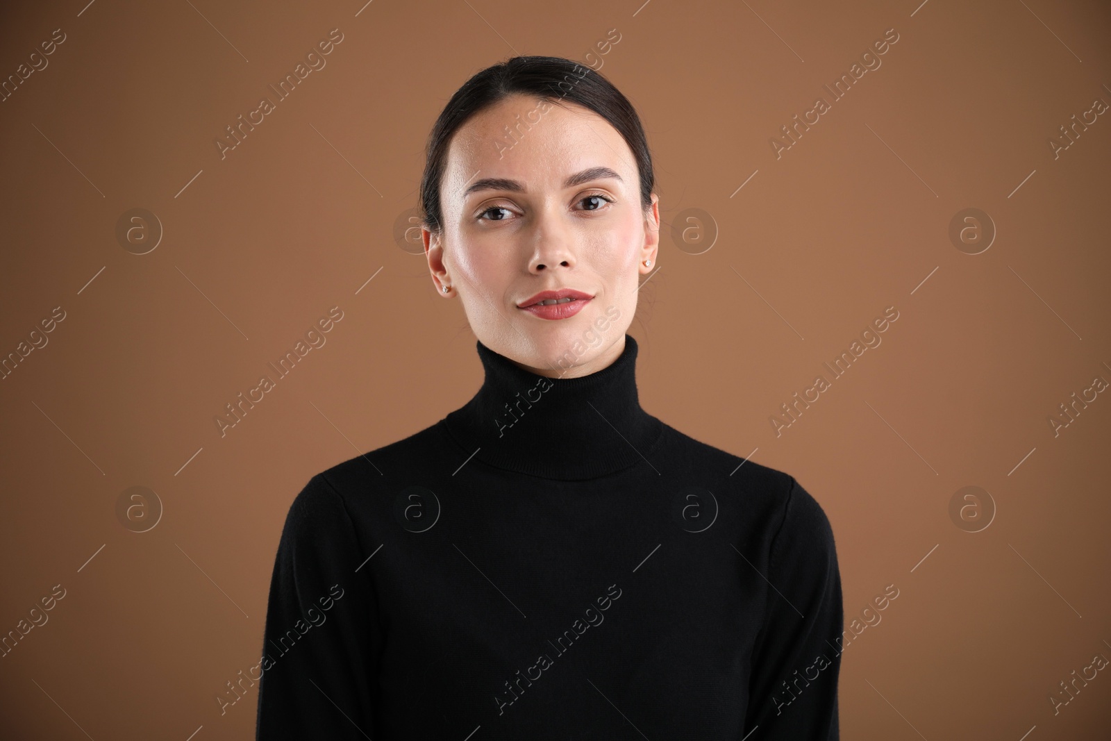 Photo of Portrait of beautiful woman on brown background