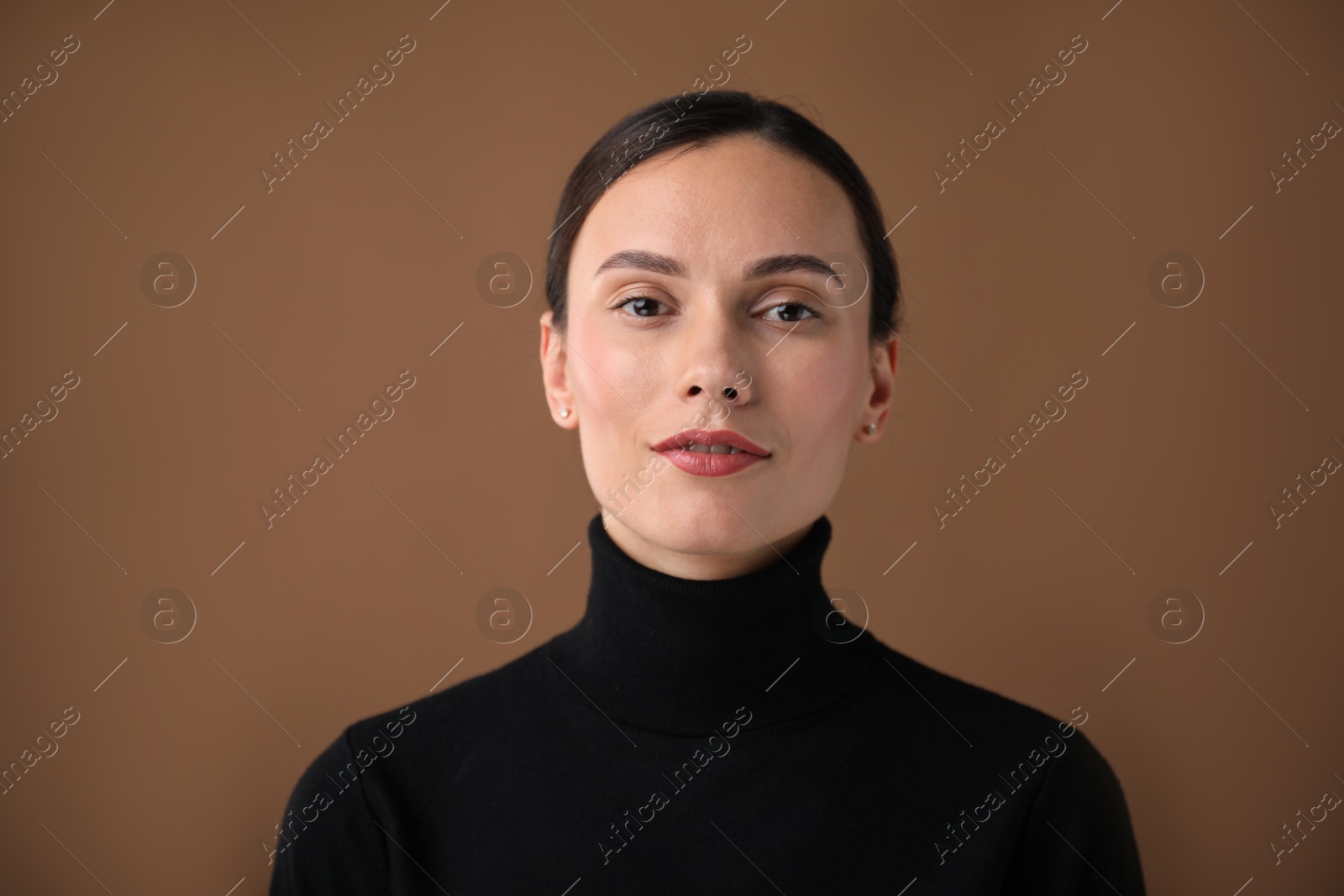 Photo of Portrait of beautiful woman on brown background
