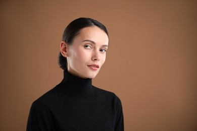 Photo of Portrait of beautiful woman on brown background. Space for text