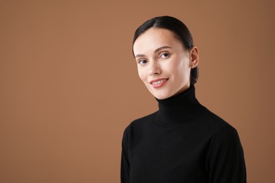Photo of Portrait of beautiful woman on brown background. Space for text
