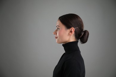 Photo of Portrait of beautiful woman on grey background. Space for text