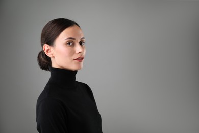 Photo of Portrait of beautiful woman on grey background. Space for text
