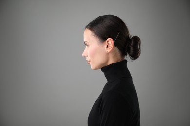 Photo of Portrait of beautiful woman on grey background. Space for text