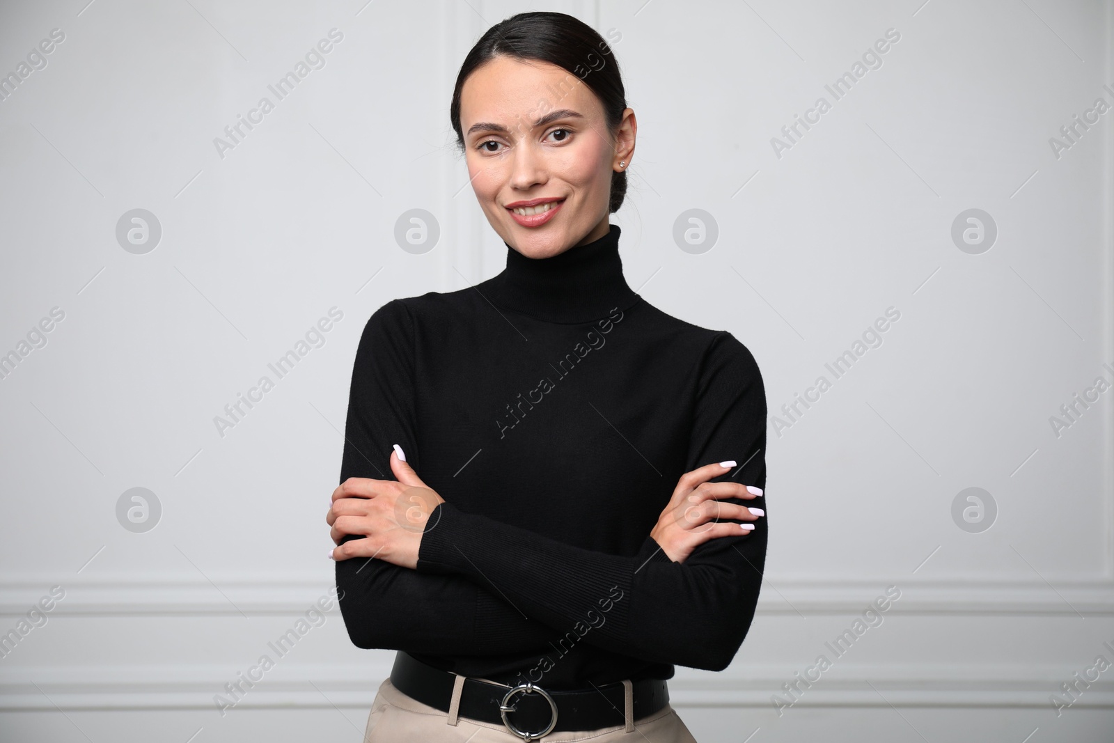 Photo of Portrait of beautiful woman near white wall