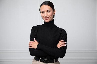 Photo of Portrait of beautiful woman near white wall