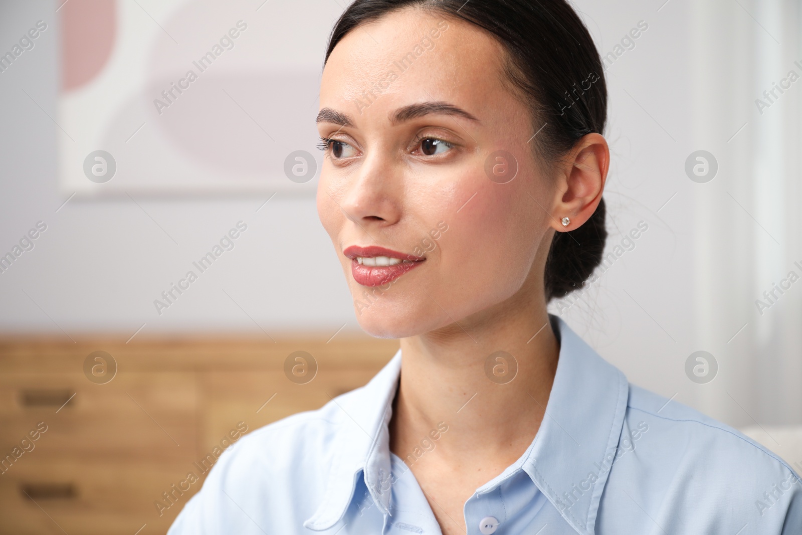 Photo of Portrait of beautiful young woman at home