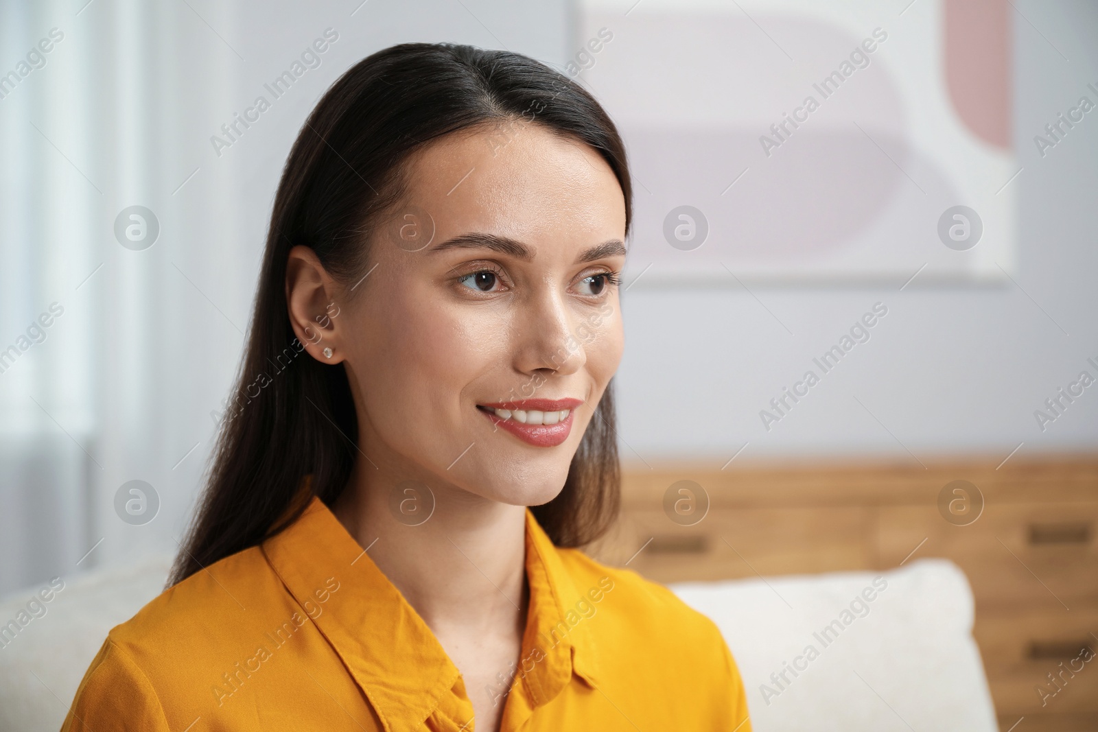 Photo of Portrait of beautiful young woman at home. Space for text