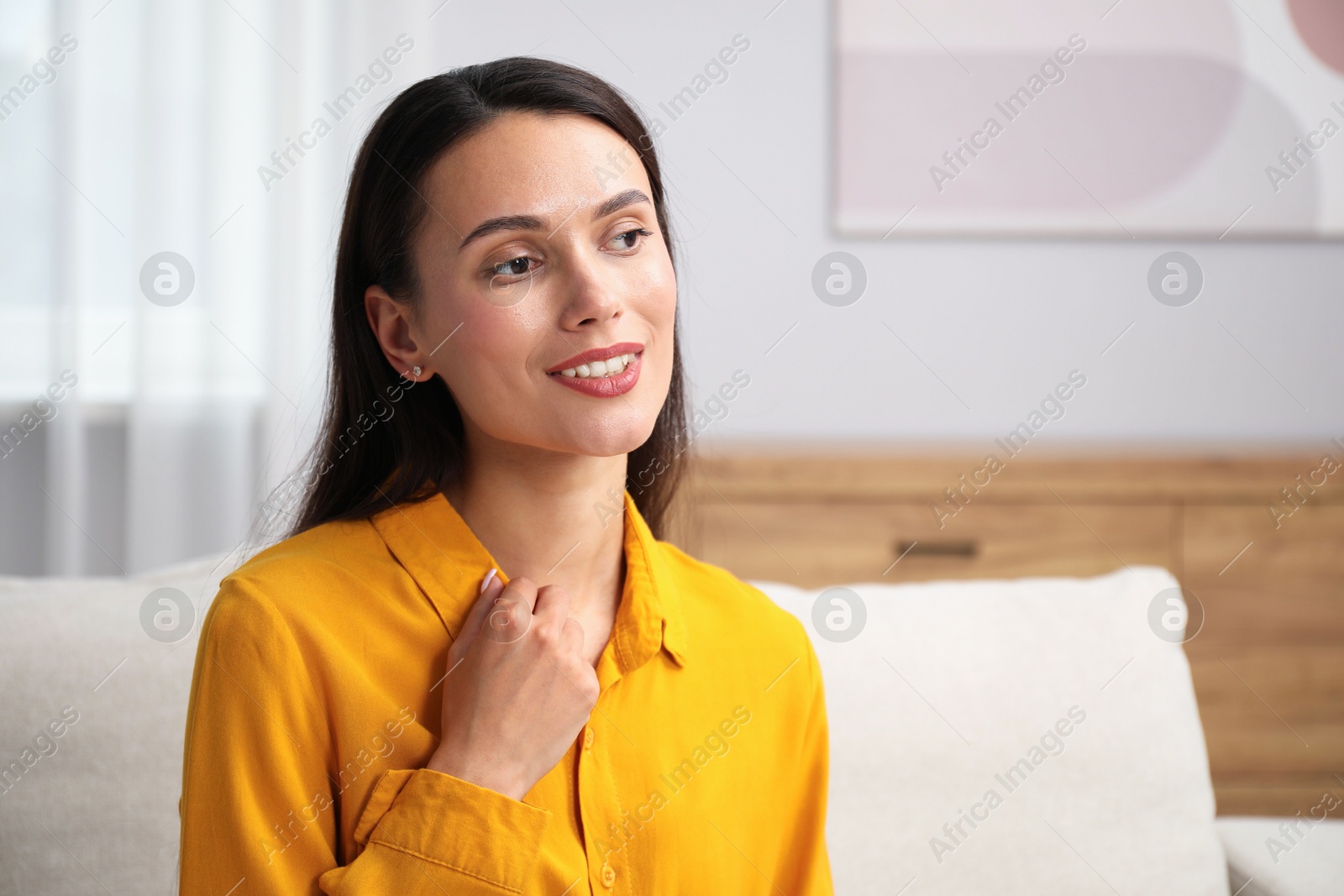 Photo of Portrait of beautiful young woman at home. Space for text