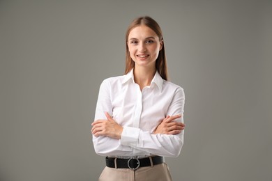 Photo of Portrait of confident businesswoman on grey background