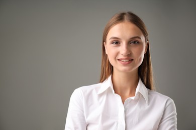 Photo of Portrait of confident businesswoman on grey background. Space for text