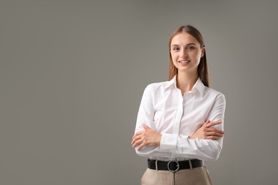 Photo of Portrait of confident businesswoman on grey background. Space for text