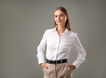 Photo of Portrait of confident businesswoman on grey background