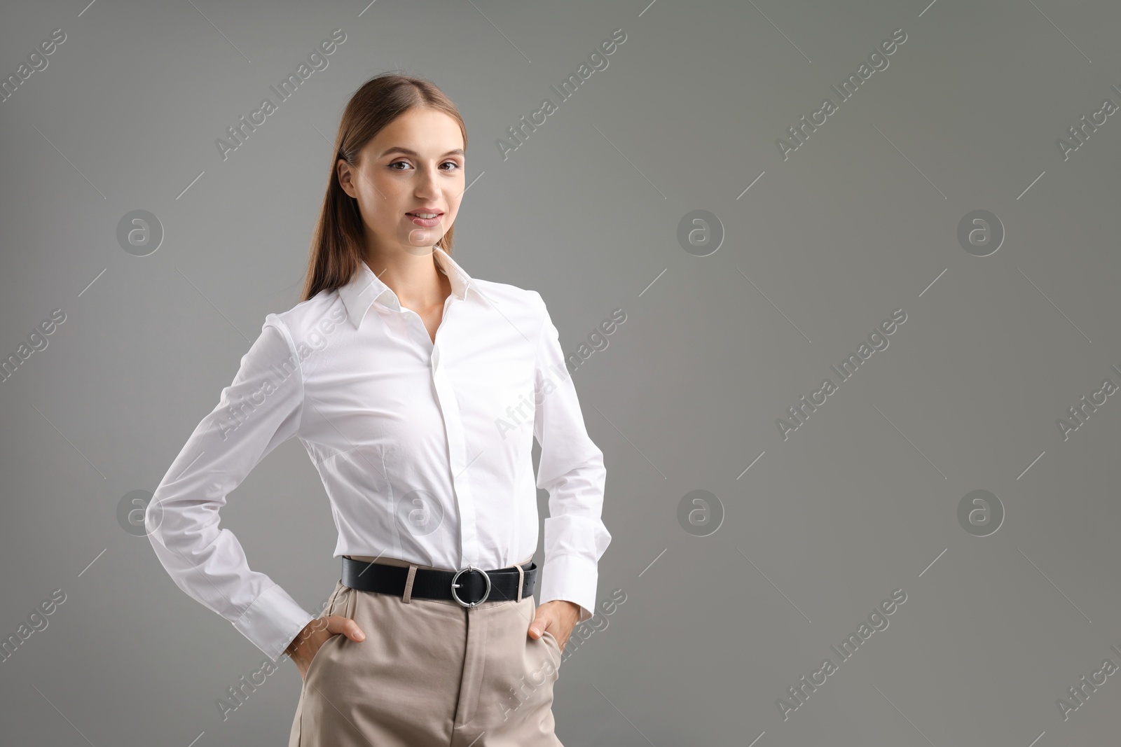 Photo of Portrait of confident businesswoman on grey background. Space for text