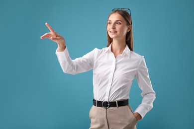 Photo of Beautiful woman pointing at something on blue background