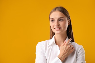 Photo of Portrait of beautiful woman on yellow background. Space for text