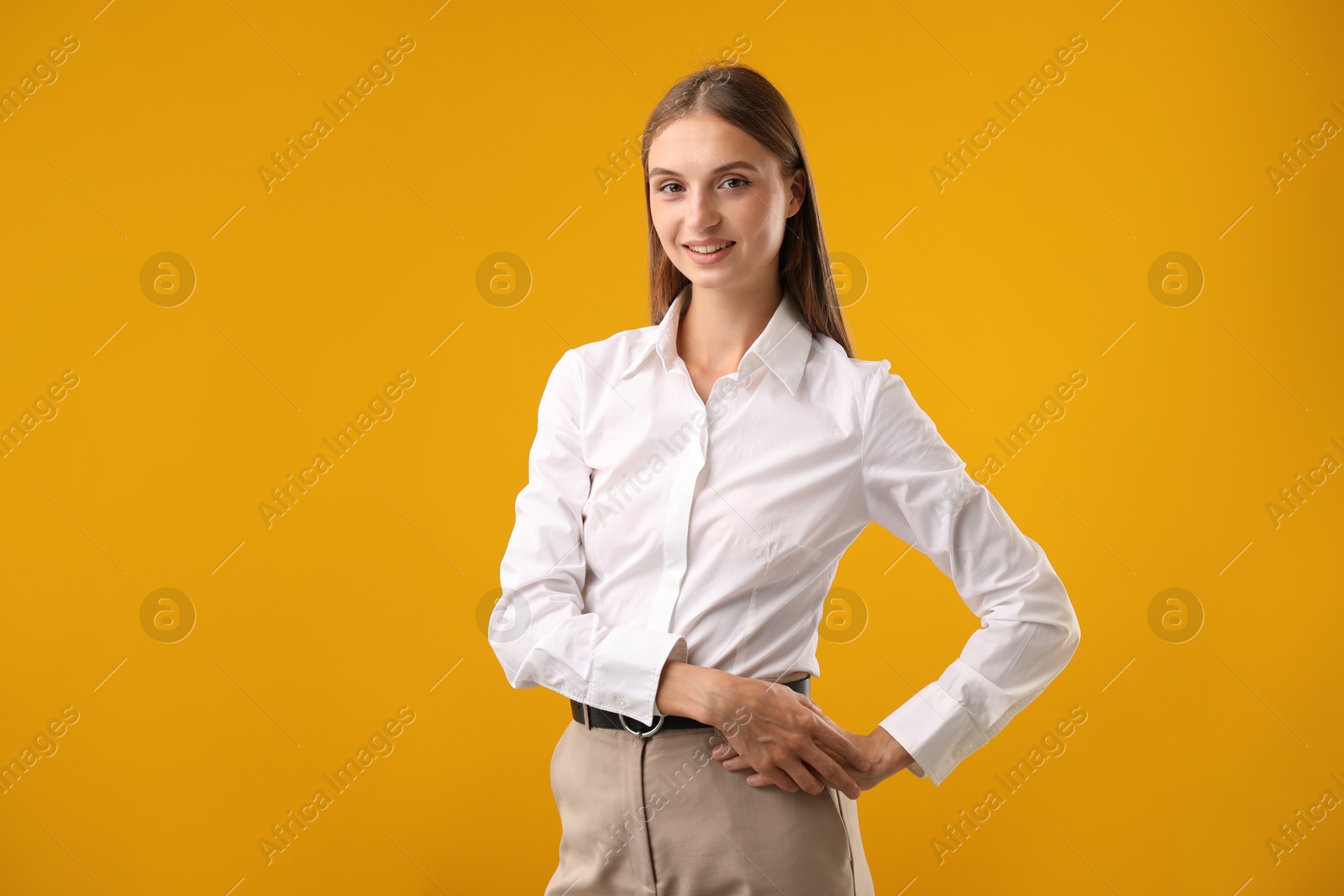 Photo of Portrait of beautiful woman on yellow background. Space for text