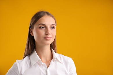 Photo of Portrait of beautiful woman on yellow background. Space for text