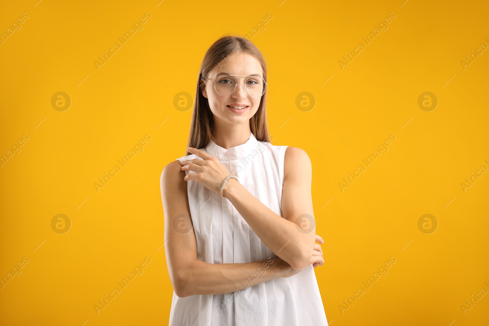 Photo of Portrait of beautiful woman on yellow background