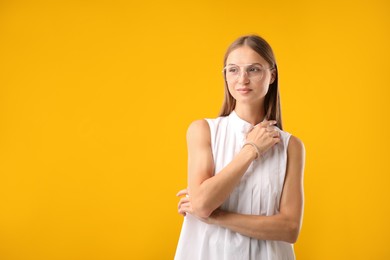 Photo of Portrait of beautiful woman on yellow background. Space for text