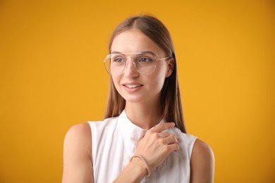 Photo of Portrait of beautiful woman on yellow background